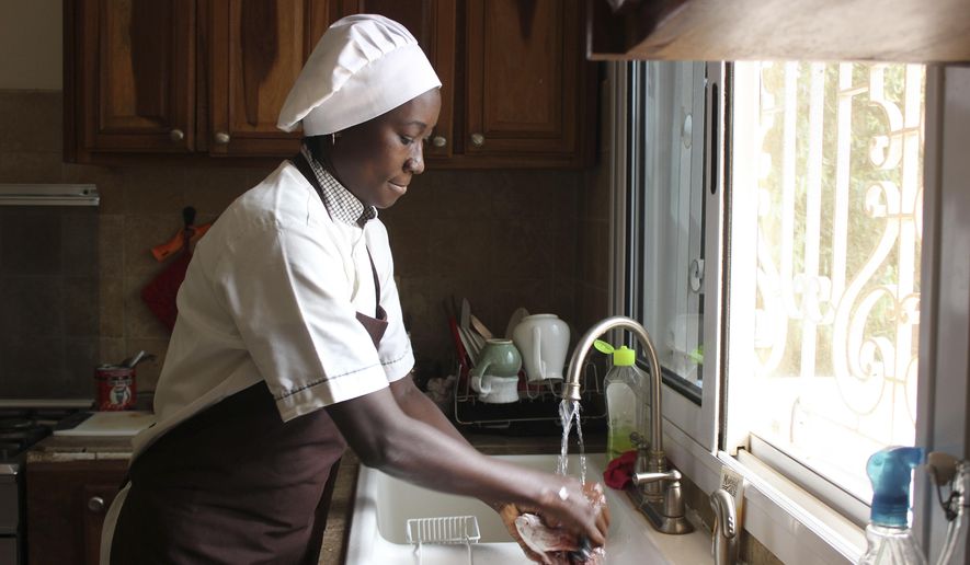 In this Nov. 24, 2018 photo, Chef Touty Sarr scrapes the scales off a red snapper to boil in the savory broth of thiebou dieune, a traditional Senegalese dish of spiced rice, inside a kitchen in Ngaparou, Senegal. After finding no reliable recipes online for Ghanaian dishes - and no photos that made the beloved food of her childhood look appetizing - Tuleka Prah started My African Food Map. She uses the blog to celebrate the cuisines of a continent often marred by negative stereotypes. The aim is to present food "how people who love it would prepare it." And she's not alone, as others explore the cuisines of the continent and its diaspora for a global audience. (AP Photo/Amelia Nierenberg)