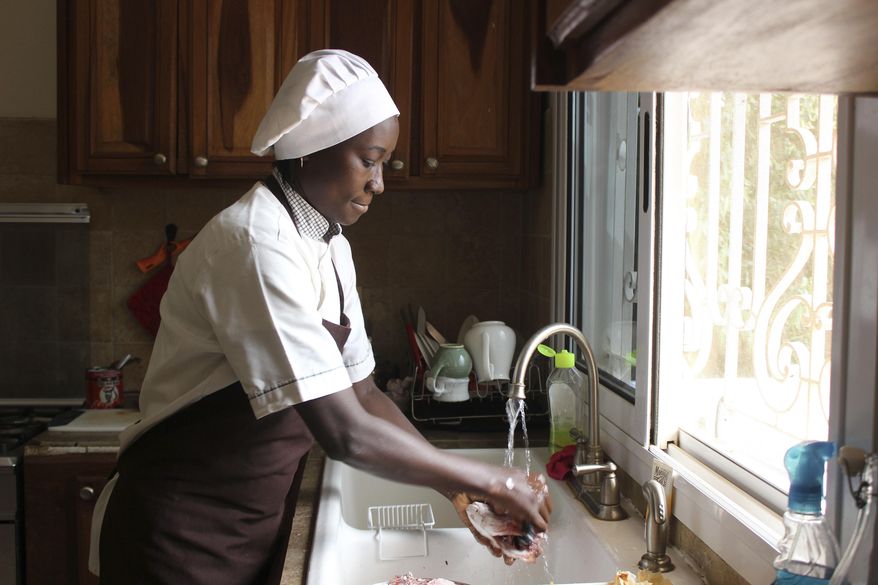 In this Nov. 24, 2018 photo, Chef Touty Sarr scrapes the scales off a red snapper to boil in the savory broth of thiebou dieune, a traditional Senegalese dish of spiced rice, inside a kitchen in Ngaparou, Senegal. After finding no reliable recipes online for Ghanaian dishes - and no photos that made the beloved food of her childhood look appetizing - Tuleka Prah started My African Food Map. She uses the blog to celebrate the cuisines of a continent often marred by negative stereotypes. The aim is to present food "how people who love it would prepare it." And she's not alone, as others explore the cuisines of the continent and its diaspora for a global audience. (AP Photo/Amelia Nierenberg)