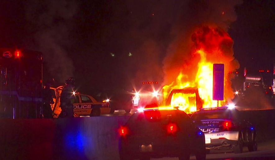 In this photo provided by LEX18, police officers and firefighters work at the scene of a deadly crash on Interstate 75 in Lexington, Ky., Sunday, Jan. 6, 2019. A suspected drunken driver heading the wrong way on a pickup truck struck a vehicle carrying several family members from Michigan early Sunday, killing all occupants of the vehicle, along with the pickup's driver, authorities said. (LEX18 via AP)