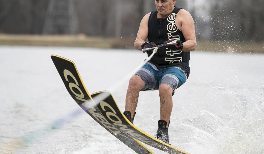 Pat Coomes, member of The Kentucky Lake Ski Nuts, looks to land a jump on Twin Oaks Lakes in Paducah, Ky., Tuesday, Jan. 1, 2019. The Kentucky Lake Ski Nuts have maintained their long-standing tradition of skiing in the new year for 40 years, as this will be the 41st consecutive New Year's Day of water skiing for the local group. The Ski Nuts are one of the top competition ski teams in the United States, however, locally the Ski Nuts seem to be best known for this New Year's Day tradition. (Ellen O'Nan/The Paducah Sun via AP)