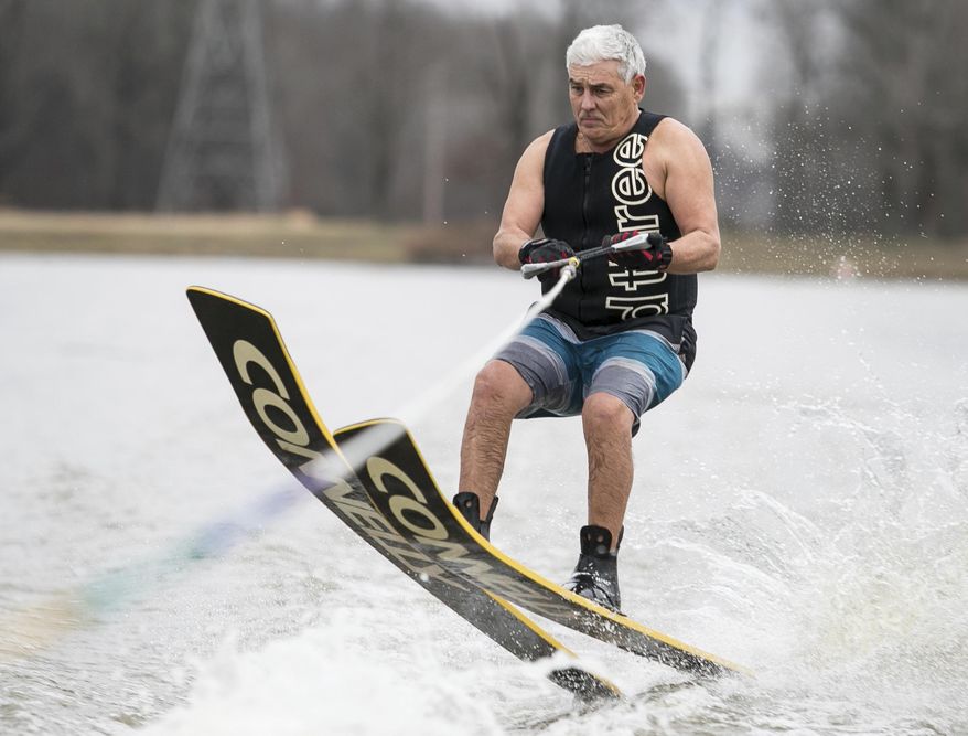 Pat Coomes, member of The Kentucky Lake Ski Nuts, looks to land a jump on Twin Oaks Lakes in Paducah, Ky., Tuesday, Jan. 1, 2019. The Kentucky Lake Ski Nuts have maintained their long-standing tradition of skiing in the new year for 40 years, as this will be the 41st consecutive New Year's Day of water skiing for the local group. The Ski Nuts are one of the top competition ski teams in the United States, however, locally the Ski Nuts seem to be best known for this New Year's Day tradition. (Ellen O'Nan/The Paducah Sun via AP)