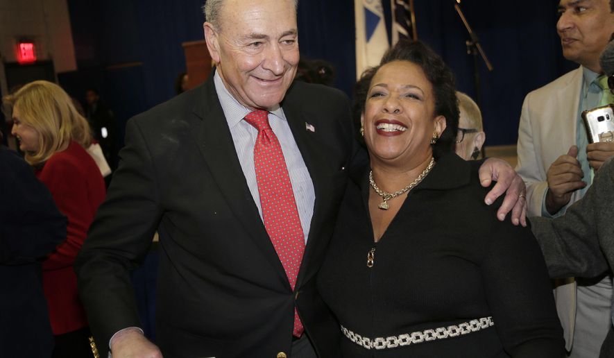 United States Senator Chuck Schumer greets former Attorney General Loretta Lynch during an inauguration ceremony for the new Attorney General of New York, Letitia James, in New York, Sunday, Jan. 6, 2019 (AP Photo/Seth Wenig)