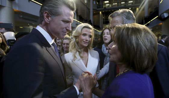 California Gov. Gavin Newsom, left, talks with U.S. House Speaker Nancy Pelosi, Monday, Jan. 7, 2019, in Sacramento, Calif. Newsom was sworn-in Monday as California's 40th governor. (AP Photo/Rich Pedroncelli)