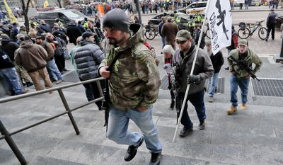 Protestors carrying rifles walk up the steps for a rally at the City County building on Monday, Jan. 7, 2019, in Pittsburgh. The protesters, many openly carrying guns, gathered in downtown Pittsburgh to rally against the city council&#39;s proposed restrictions and banning of semi-automatic rifles, certain ammunition and firearms accessories within city limits. (AP Photo/Keith Srakocic)