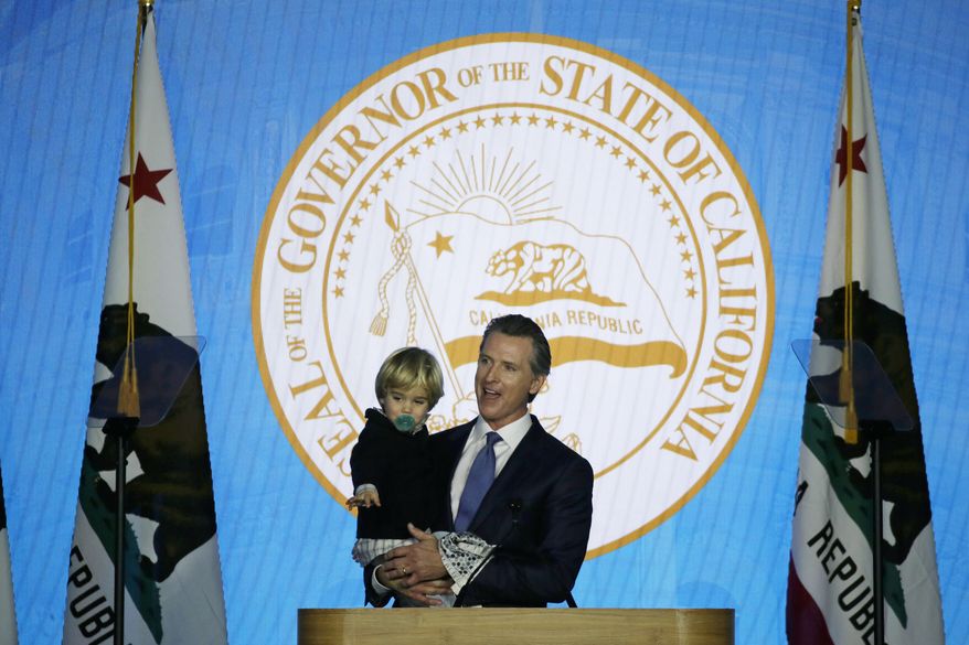 California Governor Gavin Newsom holds his son, Dutch, while speaking during his inauguration Monday, Jan. 7, 2019, in Sacramento, Calif. (AP Photo/Eric Risberg)