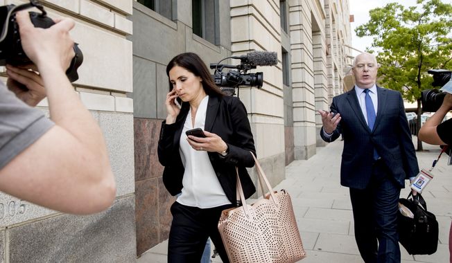 File - In this May 9, 2018 file photo, Attorneys Eric Dubelier, right, and Katherine Seikaly, left, representing Concord Management and Consulting LLC, walk out of federal court in Washington, after pleading not guilty on behalf of the company, which has been charged as part of a conspiracy to meddle in the 2016 US presidential election. A federal judge on Monday reprimanded Dubelier, saying his references to Looney Tunes and Animal House in recent court filings are inappropriate.   (AP Photo/Andrew Harnik)