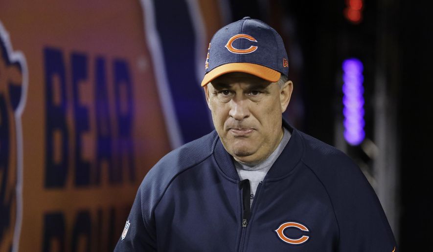 FILE - In this Dec. 9, 2018, file photo, Chicago Bears defensive coordinator Vic Fangio walks to the field before an NFL football game against the Los Angeles Rams, in Chicago. John Elway met with Bears defensive coordinator Vic Fangio about the Denver Broncos' head coaching vacancy Monday, Jan. 7, 2019, a day after Chicago's 16-15 loss to the Philadelphia Eagles in the NFC wild-card playoffs. At 60, Fangio is the oldest of the five candidates on Elway's short list as he searches for his fourth head coach in six years.(AP Photo/Nam Y. Huh, File)