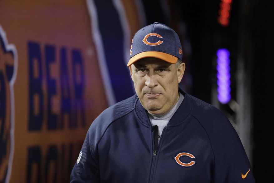 FILE - In this Dec. 9, 2018, file photo, Chicago Bears defensive coordinator Vic Fangio walks to the field before an NFL football game against the Los Angeles Rams, in Chicago. John Elway met with Bears defensive coordinator Vic Fangio about the Denver Broncos' head coaching vacancy Monday, Jan. 7, 2019, a day after Chicago's 16-15 loss to the Philadelphia Eagles in the NFC wild-card playoffs. At 60, Fangio is the oldest of the five candidates on Elway's short list as he searches for his fourth head coach in six years.(AP Photo/Nam Y. Huh, File)