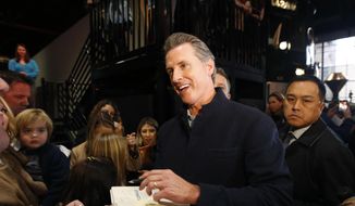 Governor-elect, Lt. Gov. Gavin Newsom, center, autographs a copy of his book, Citizenville for a well-wisher while attending a pre-inaugural Family Event held at the California Railroad Museum, Sunday, Jan. 6, 2019, in Sacramento, Calif. Newsom will be sworn-in as California&#39;s 40th governor, Monday. (AP Photo/Rich Pedroncelli)