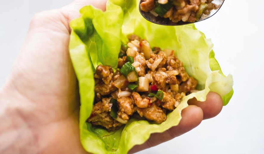 This undated photo provided by America's Test Kitchen in December 2018 shows a Asian Chicken Lettuce Wrap in Brookline, Mass. This recipe appears in the cookbook "Complete Diabetes." (Carl Tremblay/America's Test Kitchen via AP)