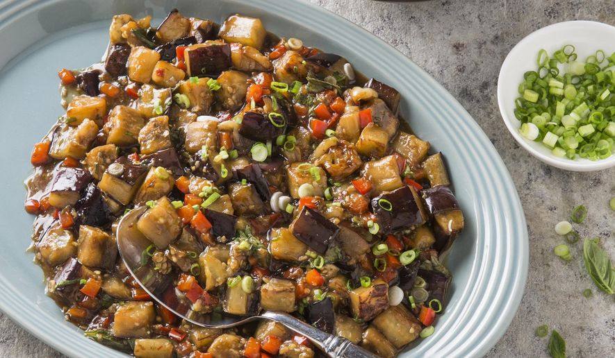 This undated photo provided by America's Test Kitchen in December 2018 shows Eggplant with Garlic and Basil Sauce in Brookline, Mass. This recipe appears in the book “Cook it in Your Dutch Oven.” (Steve Klise/America's Test Kitchen via AP)