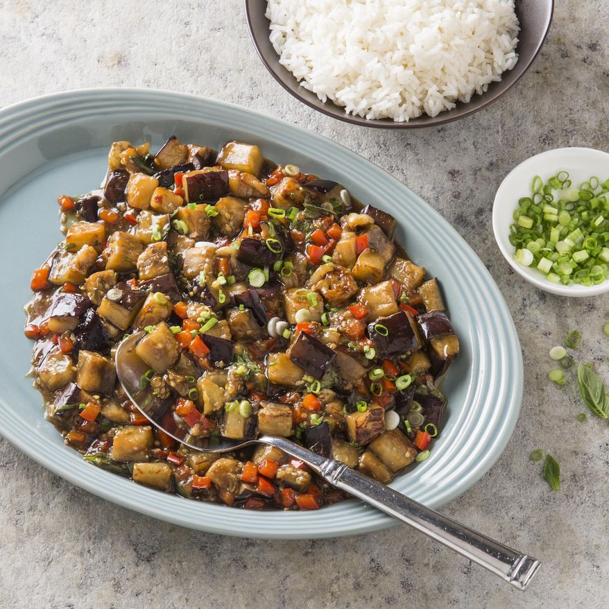 This undated photo provided by America's Test Kitchen in December 2018 shows Eggplant with Garlic and Basil Sauce in Brookline, Mass. This recipe appears in the book “Cook it in Your Dutch Oven.” (Steve Klise/America's Test Kitchen via AP)