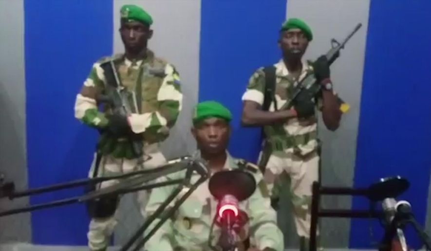 In this image from TV, a soldier who identified himself as Lt. Obiang Ondo Kelly, commander of the Republican Guard, reads a statement on state television broadcast from Libreville, saying the military has seized control of the government, Monday Jan. 7, 2019. The statement said Soldiers from Gabon&#39;s Republican Guard have launched a coup &amp;quot;to restore democracy&amp;quot; in the West African country, while imposing a curfew in the capital, and the internet has been cut.  No violence has been reported and President Ali Bongo has been out of the country since October amid reports that he had a stroke.(Gabon State TV via AP)