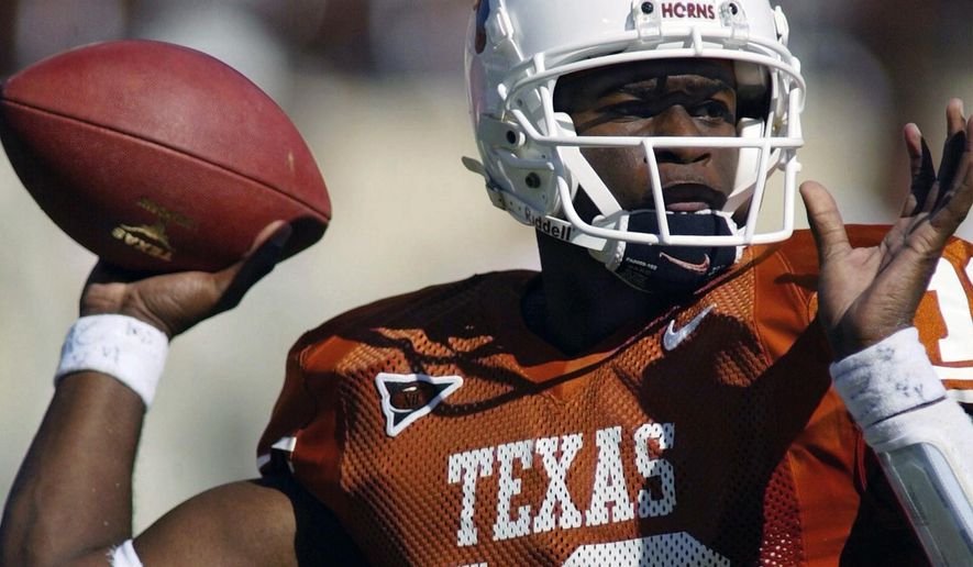 FILE - In this Oct. 16, 2004, file photo, Texas NCAA college football quarterback Vince Young looks for a receiver during the first half against Missouri, in Austin, Texas. Texas quarterback Vince Young and Notre Dame speedster Raghib Ismail have been selected, Monday, Jan. 7, 2019, for induction into the College Football Hall of Fame, along with 11 other players and two coaches. (AP Photo/Harry Cabluck, File)