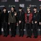 FILE- In this Dec. 14, 2018, file photo members of South Korean music band BTS pose for photos on the red carpet of the Mnet Asian Music Awards (MAMA) in Hong Kong. Mattel has signed a licensing deal with BTS.  Shares surged more than 8 percent in Monday, Jan. 7, 2019, afternoon trading. (AP Photo/Kin Cheung, File)