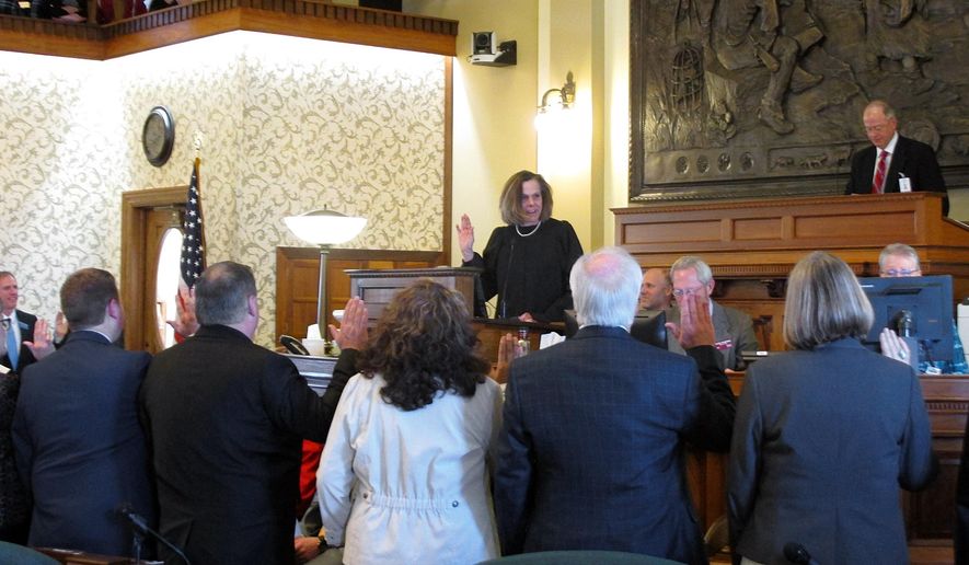 Montana Supreme Court Justice Laurie McKinnon swears in new state senators as the Montana Legislature opens its session on Monday, Jan. 7, 2019, in Helena, Mont. (AP Photo/Matt Volz)