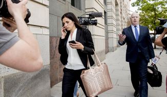File - In this May 9, 2018 file photo, Attorneys Eric Dubelier, right, and Katherine Seikaly, left, representing Concord Management and Consulting LLC, walk out of federal court in Washington, after pleading not guilty on behalf of the company, which has been charged as part of a conspiracy to meddle in the 2016 US presidential election. A federal judge on Monday reprimanded Dubelier, saying his references to Looney Tunes and “Animal House” in recent court filings are inappropriate.   (AP Photo/Andrew Harnik)