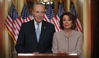 House Speaker Nancy Pelosi of Calif., and Senate Minority Leader Chuck Schumer of N.Y., pose for photographers after speaking on Capitol Hill in response President Donald Trump&#39;s prime-time address on border security, Tuesday, Jan. 8, 2019, in Washington. (AP Photo/Alex Brandon)
