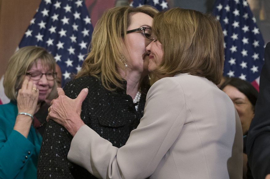 House Speaker Nancy Pelosi of Calif., right, embraces gun violence victim former Rep. Gabby Giffords, during a news conference to announce the introduction of bipartisan legislation to expand background checks for sales and transfers of firearms, on Capitol Hill, Tuesday, Jan. 8, 2019 in Washington. (AP Photo/Alex Brandon)