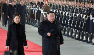 In this Monday, Jan. 7, 2019, photo provided on Tuesday, Jan. 8, 2019, by the North Korean government, North Korean leader Kim Jong-un walks with his wife Ri Sol-ju at Pyongyang Station in Pyongyang, North Korea, before leaving for China. The content of this image is as provided and cannot be independently verified. Korean language watermark on image as provided by source reads: &quot;KCNA&quot; which is the abbreviation for Korean Central News Agency. (Korean Central News Agency/Korea News Service via AP)