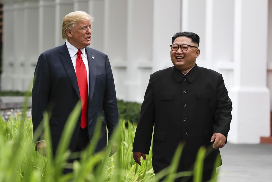 In this June 12, 2018, photo, U.S. President Donald Trump (left) and North Korea leader Kim Jong-un walk from their lunch at the Capella resort on Sentosa Island in Singapore. (Associated Press) **FILE**