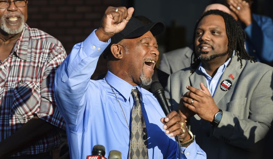 Pastor Wesley Tunstall praises God while addressing media at the Sarasota County Supervisor of Elections Office on Tuesday, Jan. 8, 2019, in Sarasota, Fla. Tunstall, a convicted felon, registered to vote on Tuesday, the first day that Amendment 4, which restores the right to vote for most felons, went into effect. (Dan Wagner/Sarasota Herald-Tribune via AP)