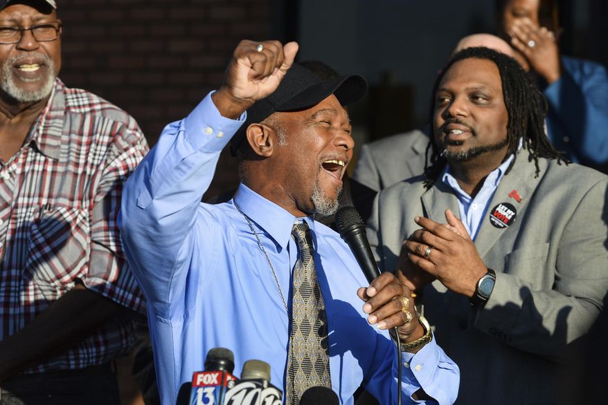 Pastor Wesley Tunstall praises God while addressing media at the Sarasota County Supervisor of Elections Office on Tuesday, Jan. 8, 2019, in Sarasota, Fla. Tunstall, a convicted felon, registered to vote on Tuesday, the first day that Amendment 4, which restores the right to vote for most felons, went into effect. (Dan Wagner/Sarasota Herald-Tribune via AP)