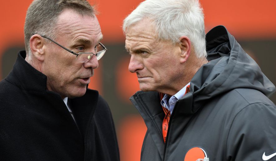 FILE - In this Dec. 10, 2017, file photo, Cleveland Browns general manager John Dorsey, left, talks with owner Jimmy Haslam before an NFL football game between the Green Bay Packers and the Cleveland Browns, in Cleveland. One week into their coaching search, the Browns are taking a timeout. After conducting interviews with seven candidates in seven days, general manager John Dorsey and members of the team’s search committee, which includes owner Jimmy Haslam, were not expected to meet with anyone on Tuesday, Jan. 8, 2019, and could be evaluating their next move.(AP Photo/David Richard, File)
