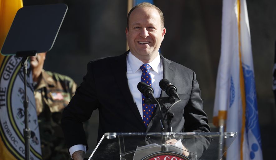 Colorado Gov. Jared Polis steps to the podium to deliver his speech after taking the oath of office to become the state's 43rd governor during his inauguration ceremony Tuesday, Jan. 8, 2019, in Denver. (AP Photo/David Zalubowski, Pool)