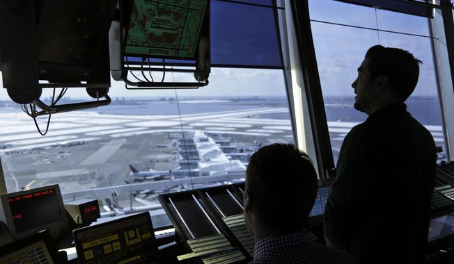 In this March 16, 2017, file photo, air traffic controllers work in the tower at John F. Kennedy International Airport in New York. The partial government shutdown is starting to affect air travelers. Over the weekend, some airports had long lines at checkpoints, apparently caused by a rising number of security officers calling in sick while they are not getting paid. (AP Photo/Seth Wenig, File)