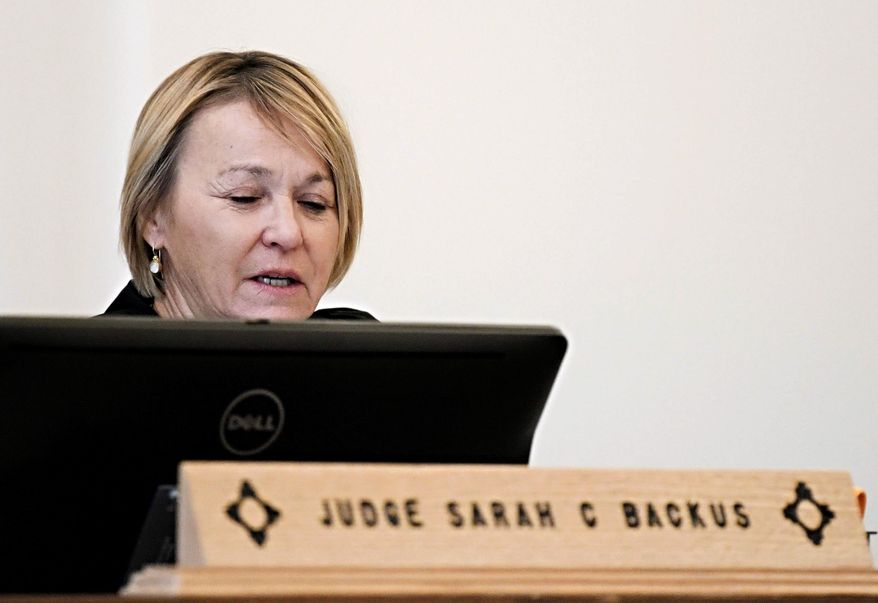 FILE - In this Aug. 13, 2018 file photo, District Court Judge Sarah C. Backus presides over the hearing in the Amalia, N.M., desert compound case in Taos, N.M. Backus who faced threats for allowing the release pending trial of suspects charged with child abuse at a ramshackle compound has announced her retirement. In a statement Tuesday, Jan. 8, 2019, Backus said she was honored to serve as judge in a district that includes Taos County, and noted her "controversial ruling" in August that cleared the way for the compound suspects' release. (Roberto E. Rosales/The Albuquerque Journal via AP, File)