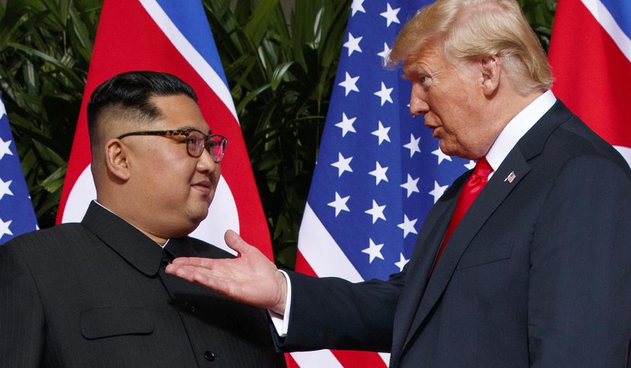 FILE - In this June 12, 2018, file photo, U.S. President Donald Trump, right, meets with North Korean leader Kim Jong Un on Sentosa Island in Singapore. While President Donald Trump waits in the wings, North Korean leader Kim Jong Un arrived in Beijing on Tuesday, Jan. 8, 2019 for his fourth summit with China’s Xi Jinping, yet another nod to the leader Kim most needs to court as he tries to undermine support for international sanctions while giving up little, if any, ground on denuclearization. (AP Photo/Evan Vucci, File)
