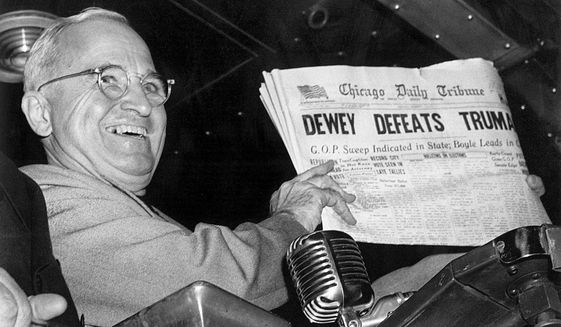FILE - In this Nov. 4, 1948, file photo, President Harry S. Truman at St. Louis&#39; Union Station holds up an election day edition of the Chicago Daily Tribune, which - based on early results - mistakenly announced &amp;quot;Dewey Defeats Truman.&amp;quot; (AP Photo/Byron Rollins)