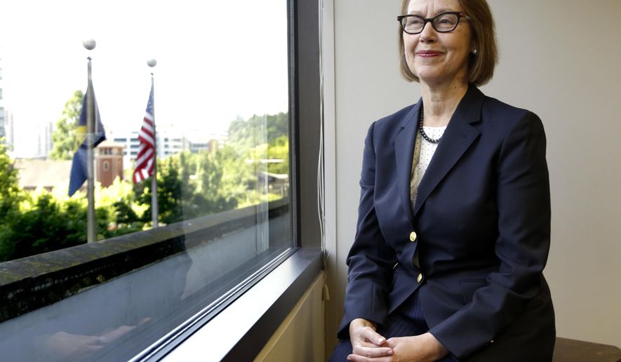 FILE - In this July 13, 2016, file photo, Oregon Attorney General Ellen Rosenblum poses for a photo at her office in Portland, Ore. Immigrants, Muslims, people of color, top law enforcement officers and state officials packed into a room on Monday, Jan. 7, 2019, to discuss the sharp rise of hate crimes in Oregon, and what to do about it. The "listening session" was organized by Rosenblum's task force on hate crimes to help craft legislation to strengthen the state's hate-crime laws. (AP Photo/Don Ryan, File)