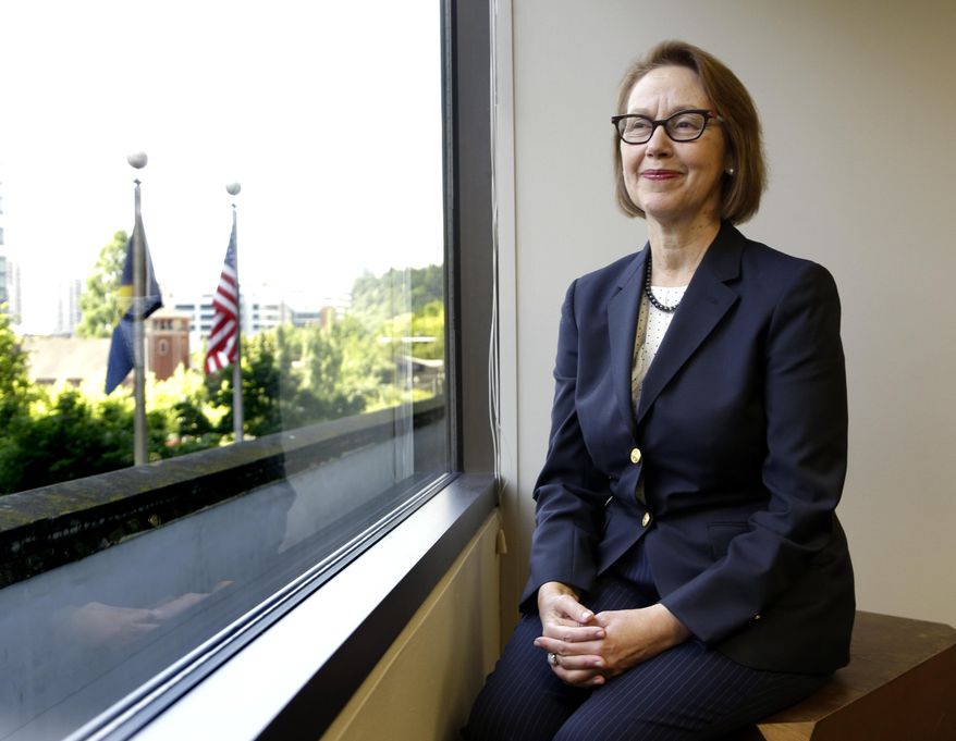 FILE - In this July 13, 2016, file photo, Oregon Attorney General Ellen Rosenblum poses for a photo at her office in Portland, Ore. Immigrants, Muslims, people of color, top law enforcement officers and state officials packed into a room on Monday, Jan. 7, 2019, to discuss the sharp rise of hate crimes in Oregon, and what to do about it. The "listening session" was organized by Rosenblum's task force on hate crimes to help craft legislation to strengthen the state's hate-crime laws. (AP Photo/Don Ryan, File)