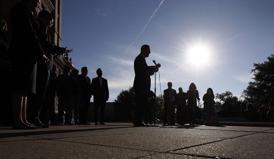 State Rep. Rafael Anchia, D-Dallas, center at microphone, takes part in a Texas Latino Education Coalition news conference on the steps of the Texas State Capitol before the opening of the 86th Texas Legislative session, Tuesday, Jan. 8, 2019, in Austin, Texas. (AP Photo/Eric Gay)
