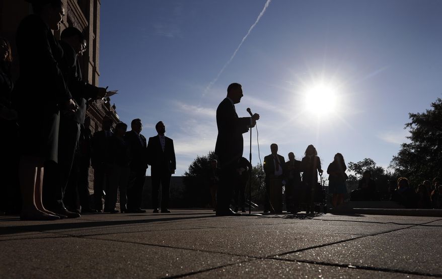 State Rep. Rafael Anchia, D-Dallas, center at microphone, takes part in a Texas Latino Education Coalition news conference on the steps of the Texas State Capitol before the opening of the 86th Texas Legislative session, Tuesday, Jan. 8, 2019, in Austin, Texas. (AP Photo/Eric Gay)