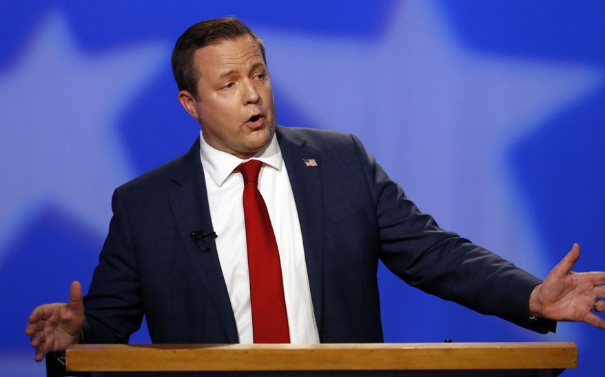 FILE - In this Oct. 2, 2018 file photo, Republican Corey Stewart gestures during a debate with U.S. Sen. Tim Kaine in Richmond, Va. Stewart who lost last year's U.S. Senate race to Democratic Sen. Tim Kaine, says he's leaving politics "until and unless the Commonwealth is ready" for his views. (AP Photo/Steve Helber, File)