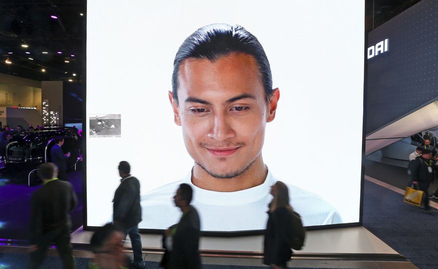 A giant KIA video screen advertises facial recognition in prototype vehicles as patrons walk past at CES International Wednesday, Jan. 9, 2019, in Las Vegas. (AP Photo/Ross D. Franklin) ** FILE **