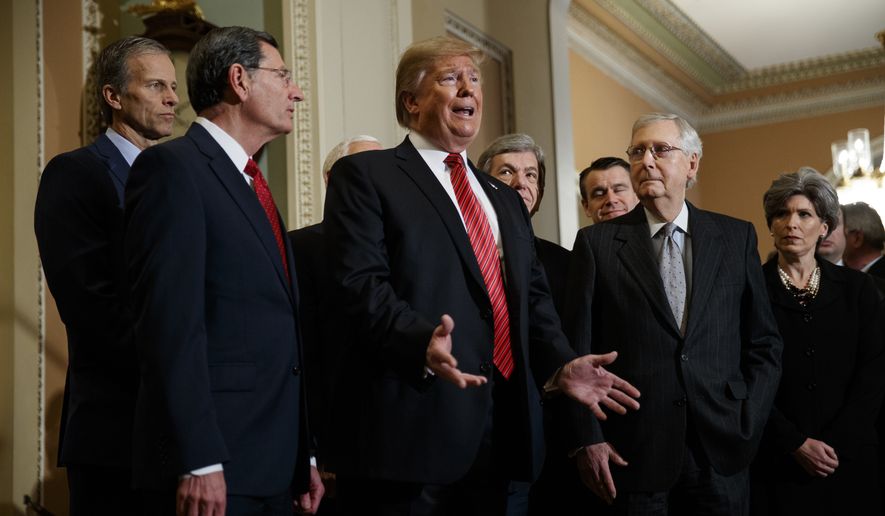 President Donald Trump speaks after attending a Senate Republican policy lunch on Capitol Hill, Wednesday, Jan. 9, 2018, in Washington, as from left, Sen. John Thune, R-S.D., Sen. John Barrasso, R-Wyo., Sen. Roy Blunt, R-Mo., Sen. Todd Young, R-Ind., Senate Majority Leader Mitch McConnell of Ky., and Sen. Joni Ernst, R-Iowa, listen. (AP Photo/ Evan Vucci)