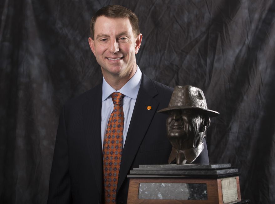 Clemson coach Dabo Swinney poses for a photograph with the Paul "Bear" Bryant Coach of the Year Award, before the ceremony Wednesday, Jan. 9, 2019, in Houston. (Yi-Chin Lee/Houston Chronicle via AP)