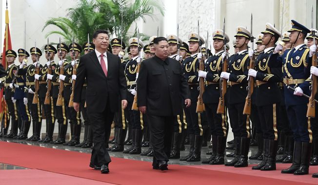 In this Tuesday, Jan. 8, 2019, photo released by China&#x27;s Xinhua News Agency, Chinese President Xi Jinping, left, and North Korean leader Kim Jong Un review an honor guard during a welcome ceremony at the Great Hall of the People in Beijing. A special train believed to be carrying Kim Jong Un departed Beijing on Wednesday after a two-day visit by the North Korean leader to the Chinese capital. (Shen Hong/Xinhua via AP)
