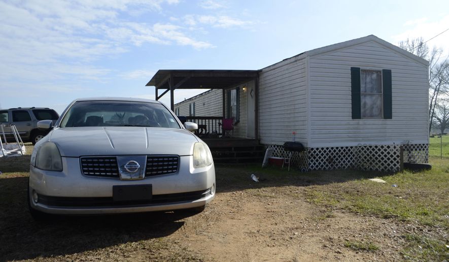 In this Tuesday, Jan. 8, 2019 photo, Ericka Hall's car is parked next to the family's single-wide trailer outside of Magnolia, Miss. Authorities say two sisters are accused of fatally stabbing and shooting their mother Ericka Hall in southwest Mississippi. (Matt Williamson/The Enterprise-Journal via AP)