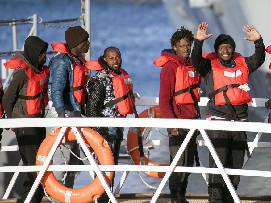 Migrants wave as they disembark at Hay Wharf, Pieta, Malta, Wednesday, Jan. 9, 2019. The 49 rescued migrants who were stranded at sea since last month were brought to Malta and then distributed among eight European Union countries. The deal, announced by Maltese Prime Minister Joseph Muscat, breaks a stalemate that began after 32 were rescued by a German aid group&#x27;s vessel on Dec. 22. The other 17 were rescued on Dec. 29 by a different aid boat. Both Italy and Malta have refused to let private rescue ships bring migrants to their shores. (AP Photo/Rene Rossignaud)