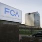 In this May 6, 2014, file photo, a vehicle moves past a sign outside Fiat Chrysler Automobiles world headquarters in Auburn Hills, Mich. (AP Photo/Carlos Osorio, File)