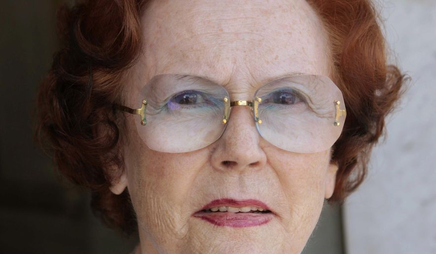 In this photo taken on Sept. 27, 2010, Jeanne Augier poses for a photographer outside the Negresco hotel in Nice, French Riviera, France. Jeanne Augier, the millionaire owner of a luxury French Riviera hotel cherished by celebrities and royalty, has died at 95. The Hotel Negresco in Nice announced in a statement that Augier died on Monday, Jan. 7, 2019, after taking over the hotel in 1957 and working to "extend its influence throughout France and the world." (Sipa via AP)
