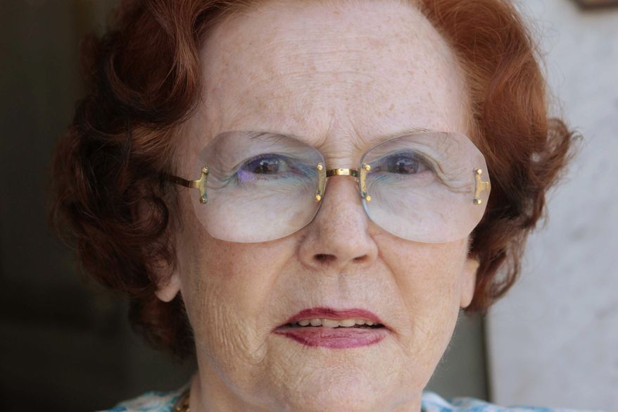In this photo taken on Sept. 27, 2010, Jeanne Augier poses for a photographer outside the Negresco hotel in Nice, French Riviera, France. Jeanne Augier, the millionaire owner of a luxury French Riviera hotel cherished by celebrities and royalty, has died at 95. The Hotel Negresco in Nice announced in a statement that Augier died on Monday, Jan. 7, 2019, after taking over the hotel in 1957 and working to "extend its influence throughout France and the world." (Sipa via AP)