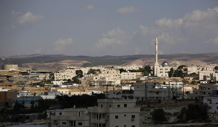 FILE - This Oct. 20, 2014 file photo, shows a view of Hura, a predominantly Bedouin town in the Israeli Negev desert. Israel has begun cracking down on polygamy among the country’s Bedouins, after decades of turning a blind eye to the old custom that remains widespread in the community. But many Bedouins, complaining of systematic neglect and discrimination by Israeli governments, see only a ploy to curb their population growth and criminalize their community members. (AP Photo/Tsafrir Abayov, File)