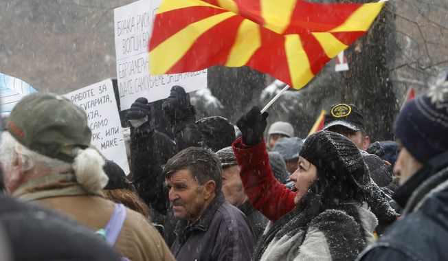 Opponents to the change of the country&#x27;s constitutional name protest outside the parliament building prior to a session of the Macedonian Parliament in the capital Skopje, Wednesday, Jan. 9, 2019. Macedonian lawmakers are entering the last phase of debate on constitutional changes to rename their country North Macedonia as part of a deal with neighboring Greece to pave the way for NATO membership and eventually joining the European Union. (AP Photo/Boris Grdanoski)