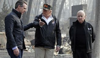 President Donald Trump talks with then Gov.-elect Gavin Newsom (left) as California Gov. Jerry Brown listens during a visit to a neighborhood impacted by the Camp wildfire in Paradise, Calif. (AP Photo/Evan Vucci, File)